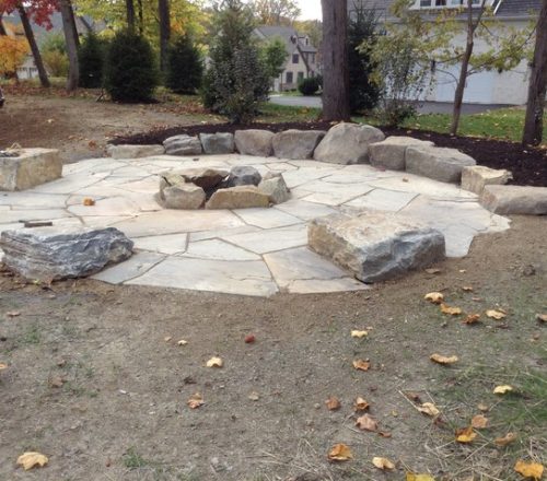 large-fire-pit-area-with-boulder-tables-and-rock-wall-seating-custom-cut-irreg-allegheny-gardens-landscaping-img~a791799204b3bf73_4-0257-1-bc5da19